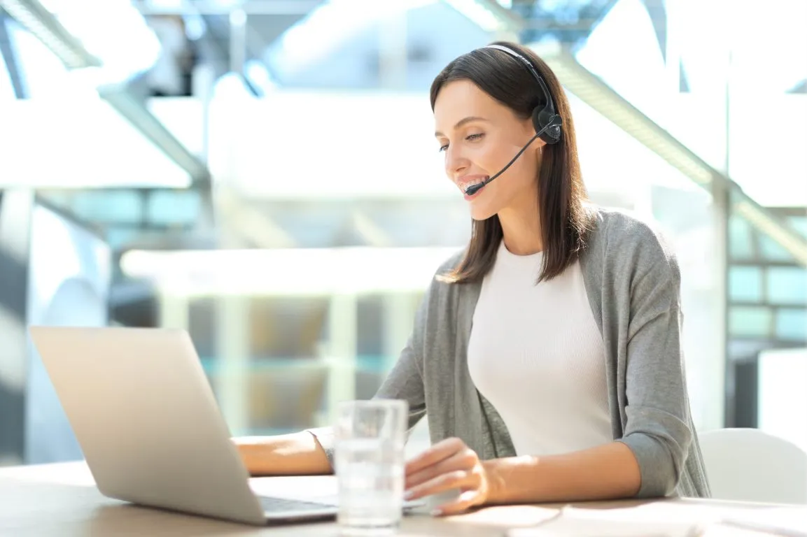 Conseillère du support Forekasts avec un casque, devant son ordinateur